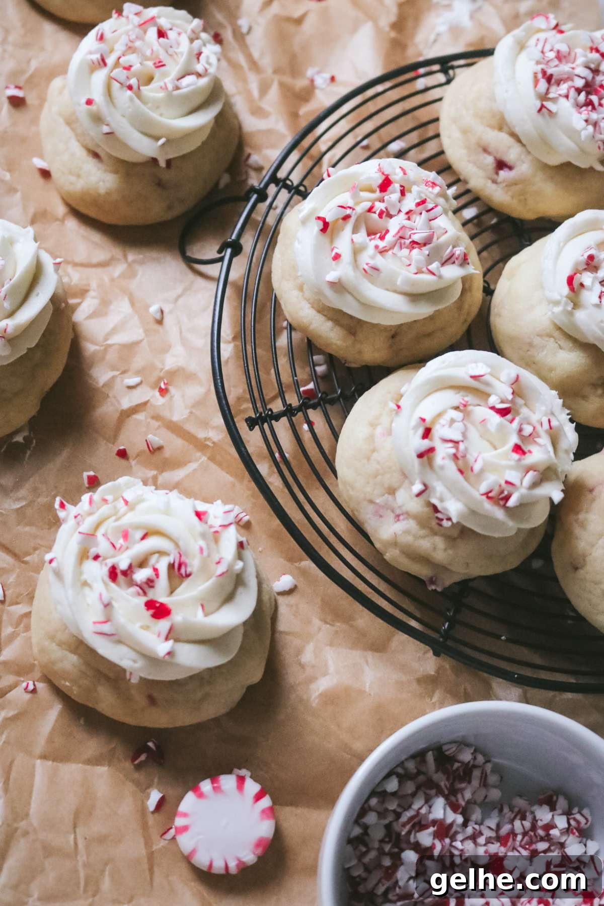 overhead view of a wire rack with peppermint sugar cookies topped with crushed candy cane pieces.