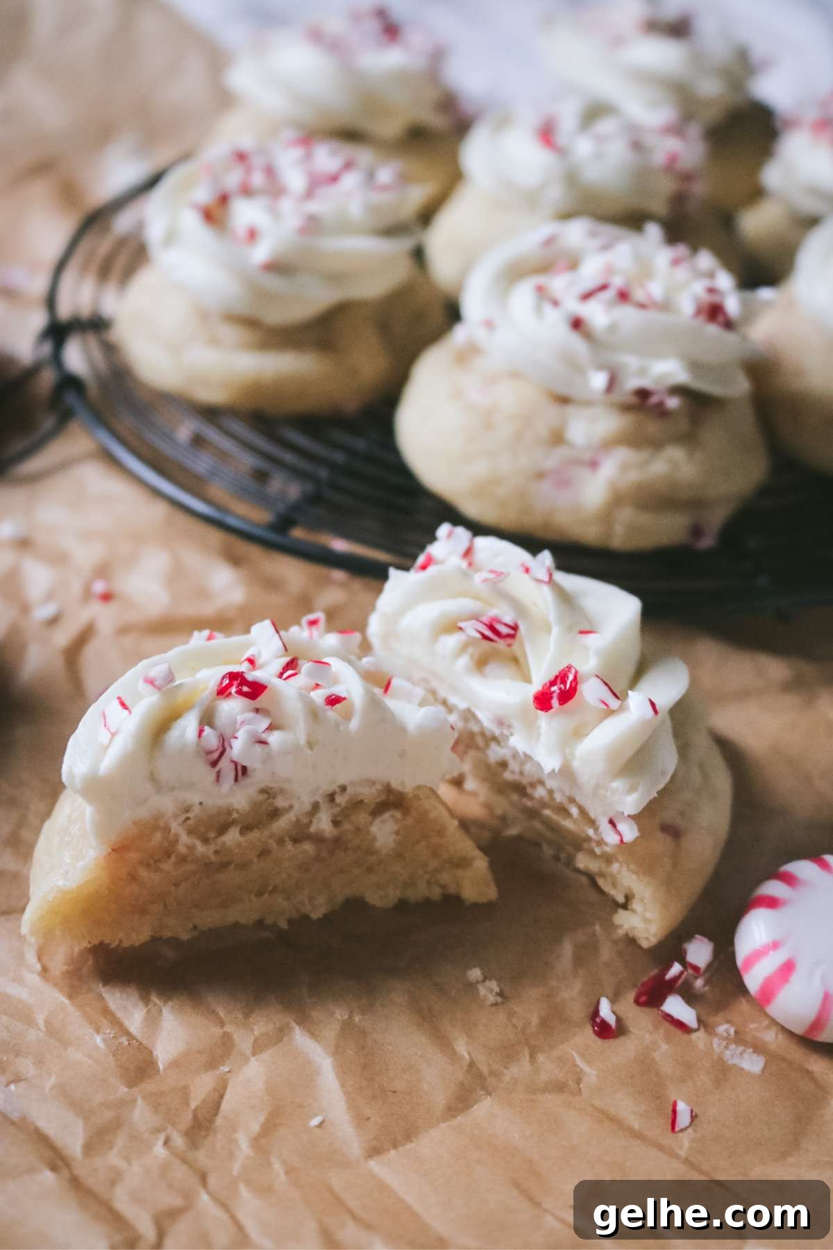close up of a sliced frosted peppermint sugar cookie to show how soft it is on the inside.