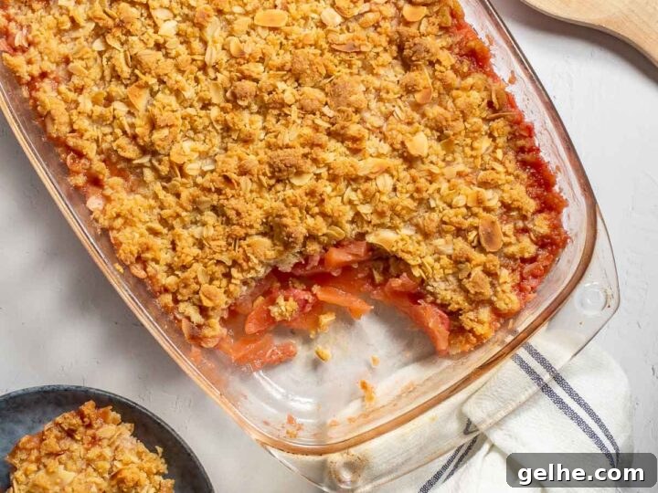 Top-down view of a fruit crisp in a glass dish.