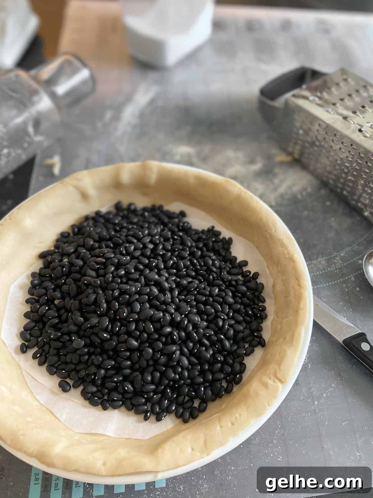 Classic Southern Pecan Pie Recipe: Authentic, Easy-to-Follow Instructions 4 Parchment paper and dried black beans in uncooked pie shell.