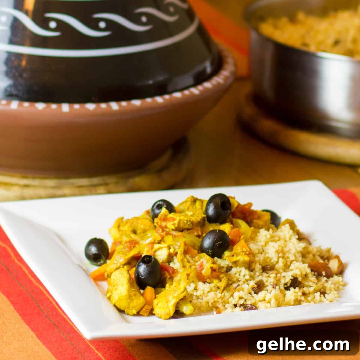 Mediterranean Chicken Tagine with Black Olives and Preserved Lemon 6 Tagine with chicken and black olives on a plate.
