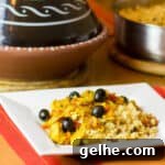 Mediterranean Chicken Tagine with Black Olives and Preserved Lemon 7 Tagine with chicken and black olives on a plate.