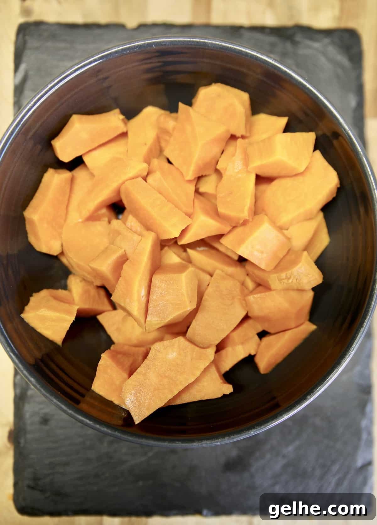 How to make sweet potato casserole without marshmallows. Bowl of diced sweet potatoes.