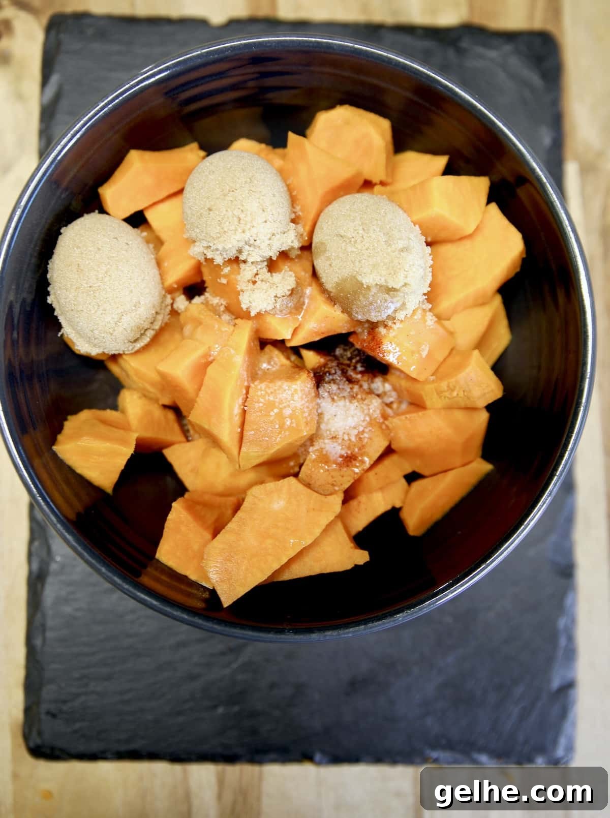 Ultimate Grilled Sweet Potato Casserole Recipe for Summer BBQ 2 Bowl of chopped sweet potatoes with brown sugar & butter.