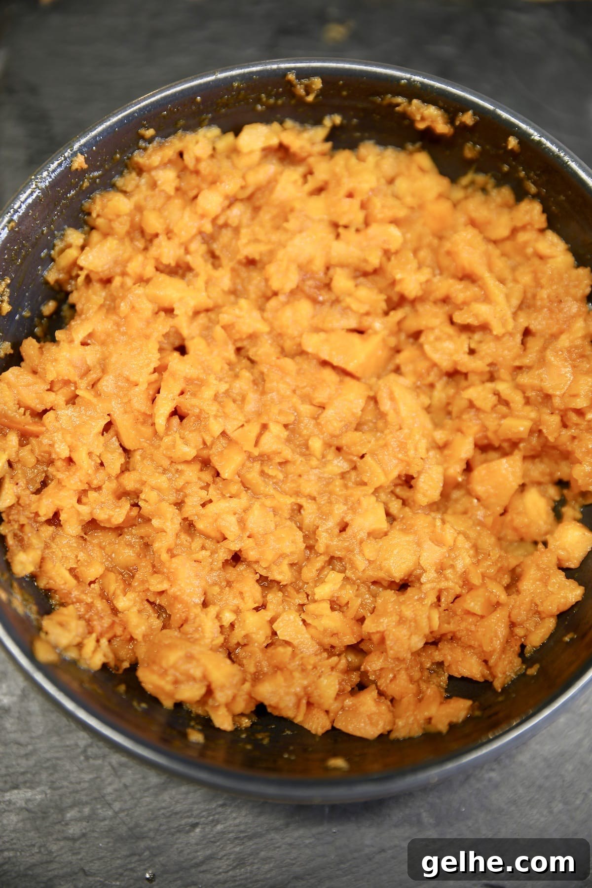 Mashed sweet potatoes- easy side dish. Bowl of coarsely mashed sweet potatoes.