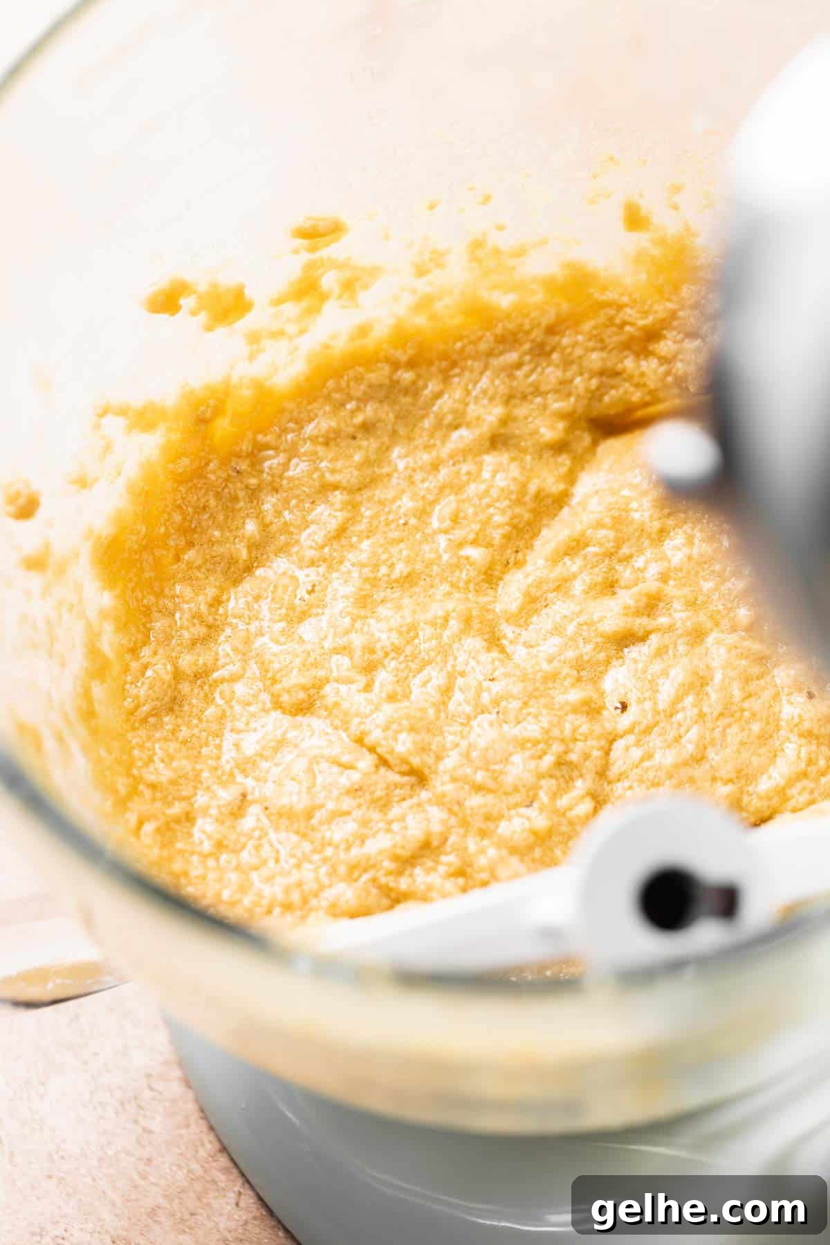 A stand mixing bowl with the creamed butter, sugar, and eggs mixed together.