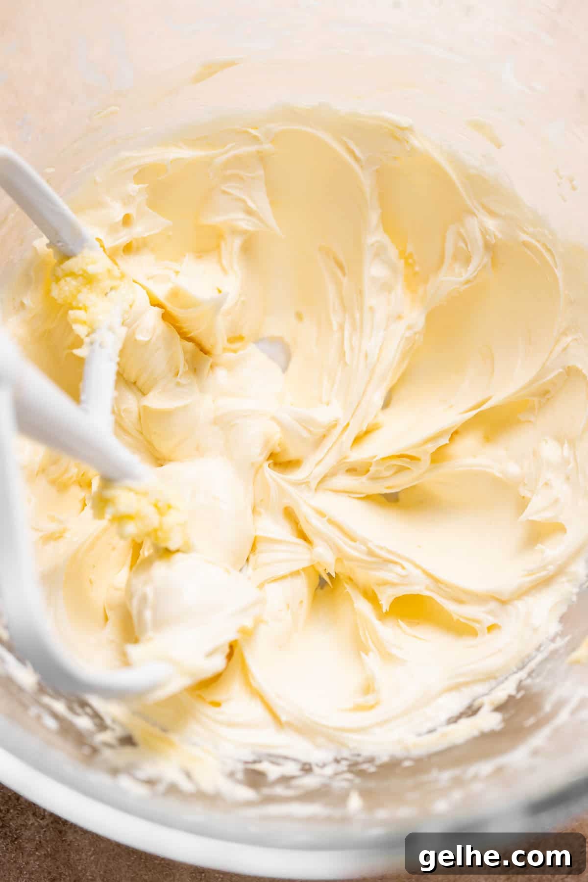 A mixing bowl with the vanilla buttercream frosting in it.