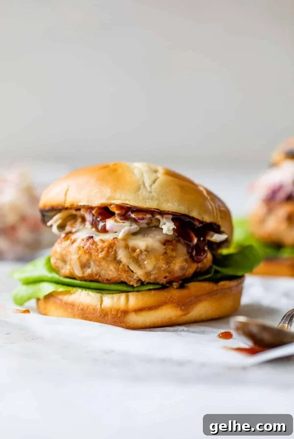 bbq chicken burger on a bun with homemade coleslaw on top