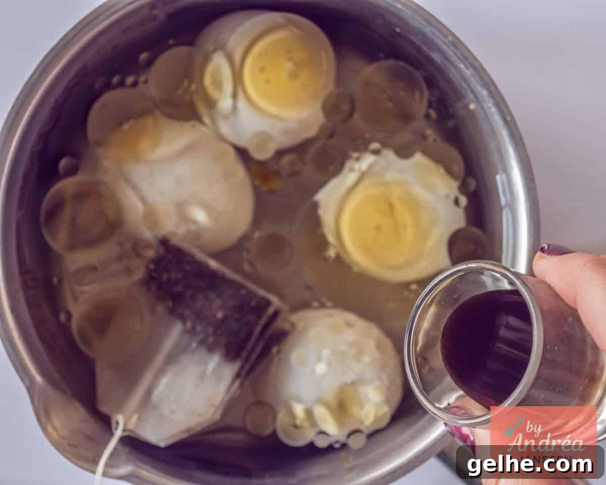 How to Make Chinese Tea Eggs: Savory Marble Egg Recipe 5 A saucepan with eggs where tea and soy sauce and sesame oil are added