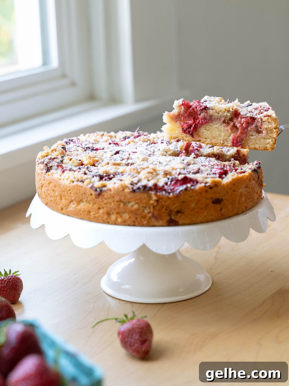 A slice being removed from a balsamic strawberry cake