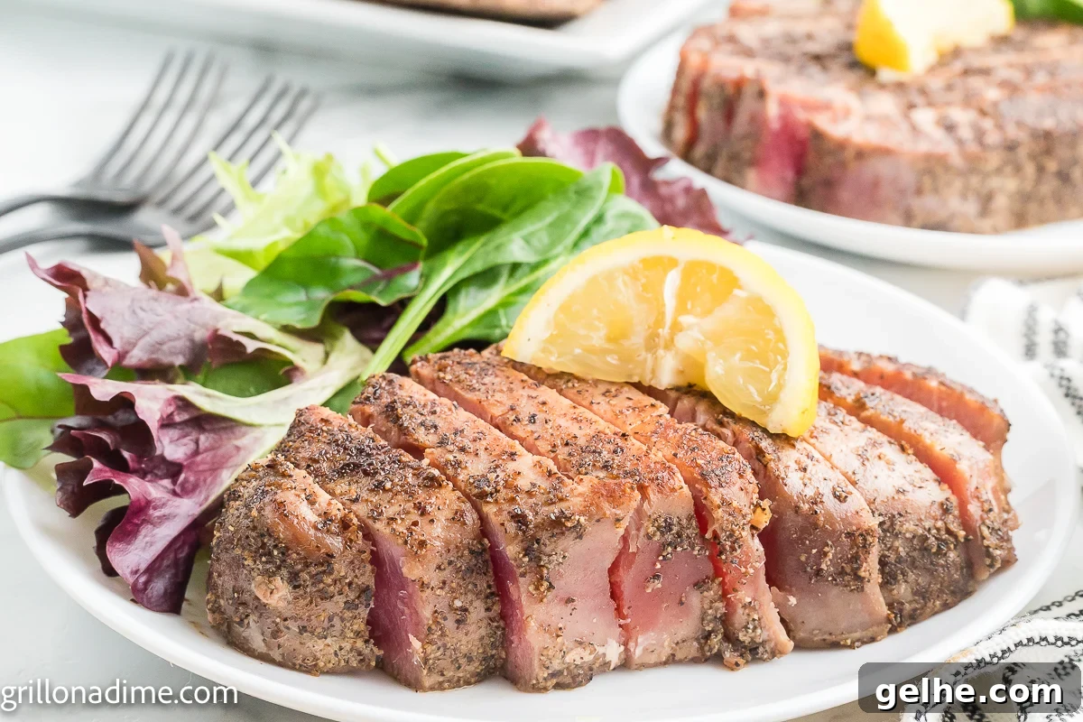 Tuna Steaks sliced on a plate with green salad
