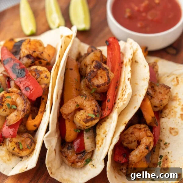 Grilled shrimp tacos with peppers and tomatoes.