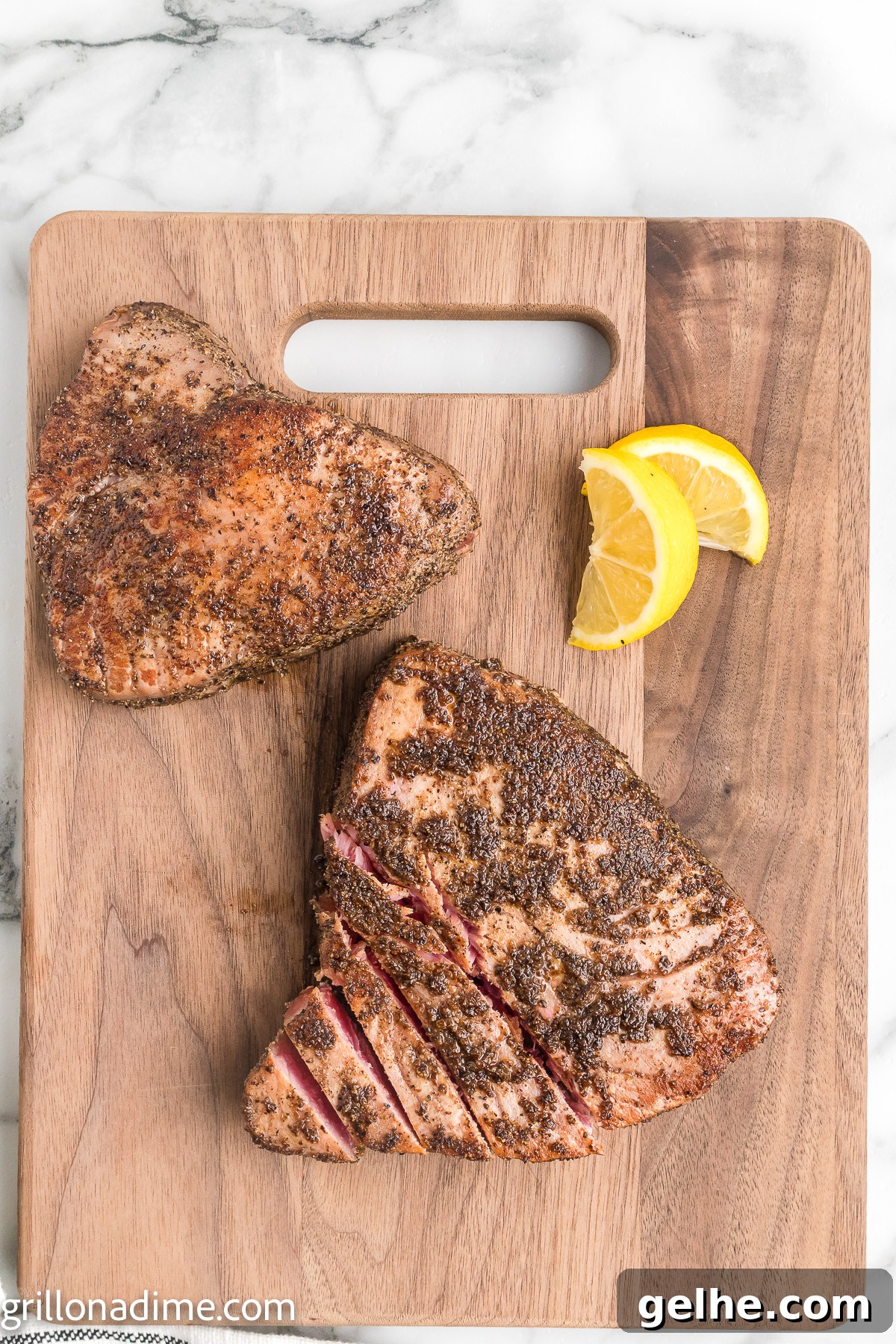 Tuna Steaks on a cutting board with fresh lemon