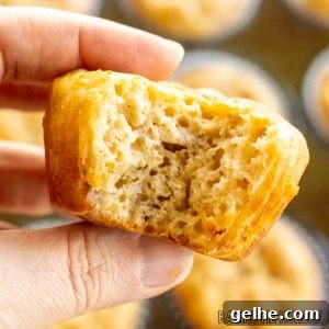 Banana and Cottage Cheese Muffins with Moist Texture 16 hand holding one of the banana cottage cheese muffins missing a bite