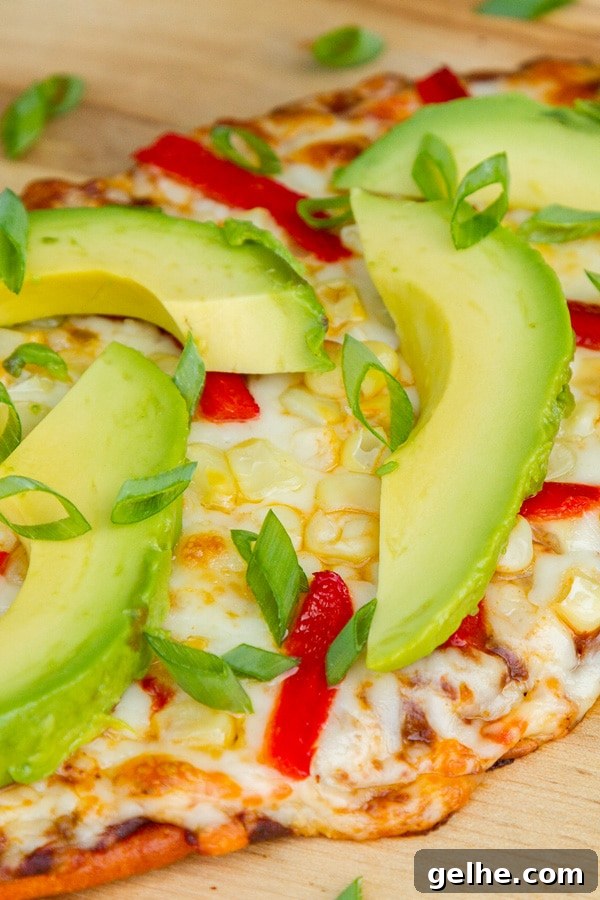 close up on a cheesy flatbread where the cheese is dripping off the side.