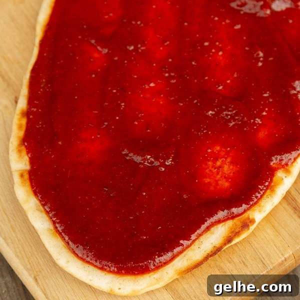 flatbread pizza with enchilada sauce on top.