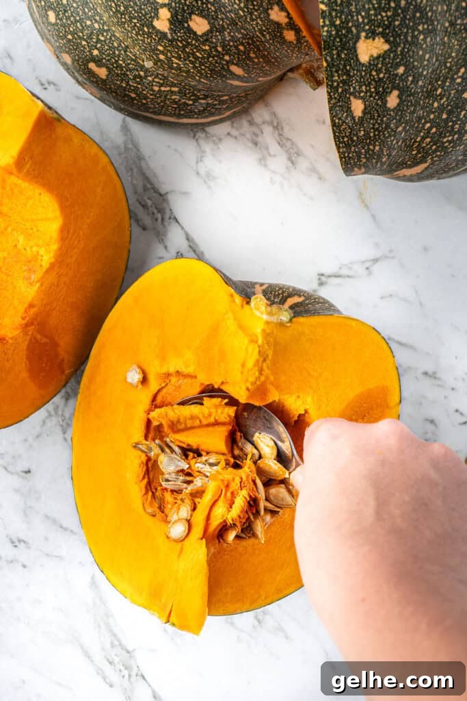 How to Make Smooth Homemade Pumpkin Puree for Baking 6 Scooping out the seeds from the pumpkin using a spoon.
