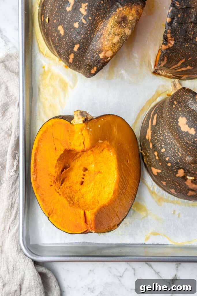 How to Make Smooth Homemade Pumpkin Puree for Baking 9 Cooked pumpkin on a baking sheet with a fork prick hole.