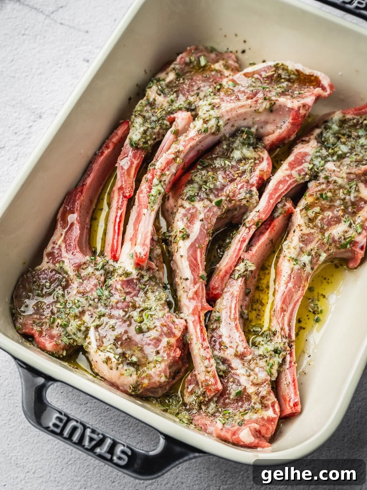 Lamb chops in a tray seasoned with the prepared marinade.