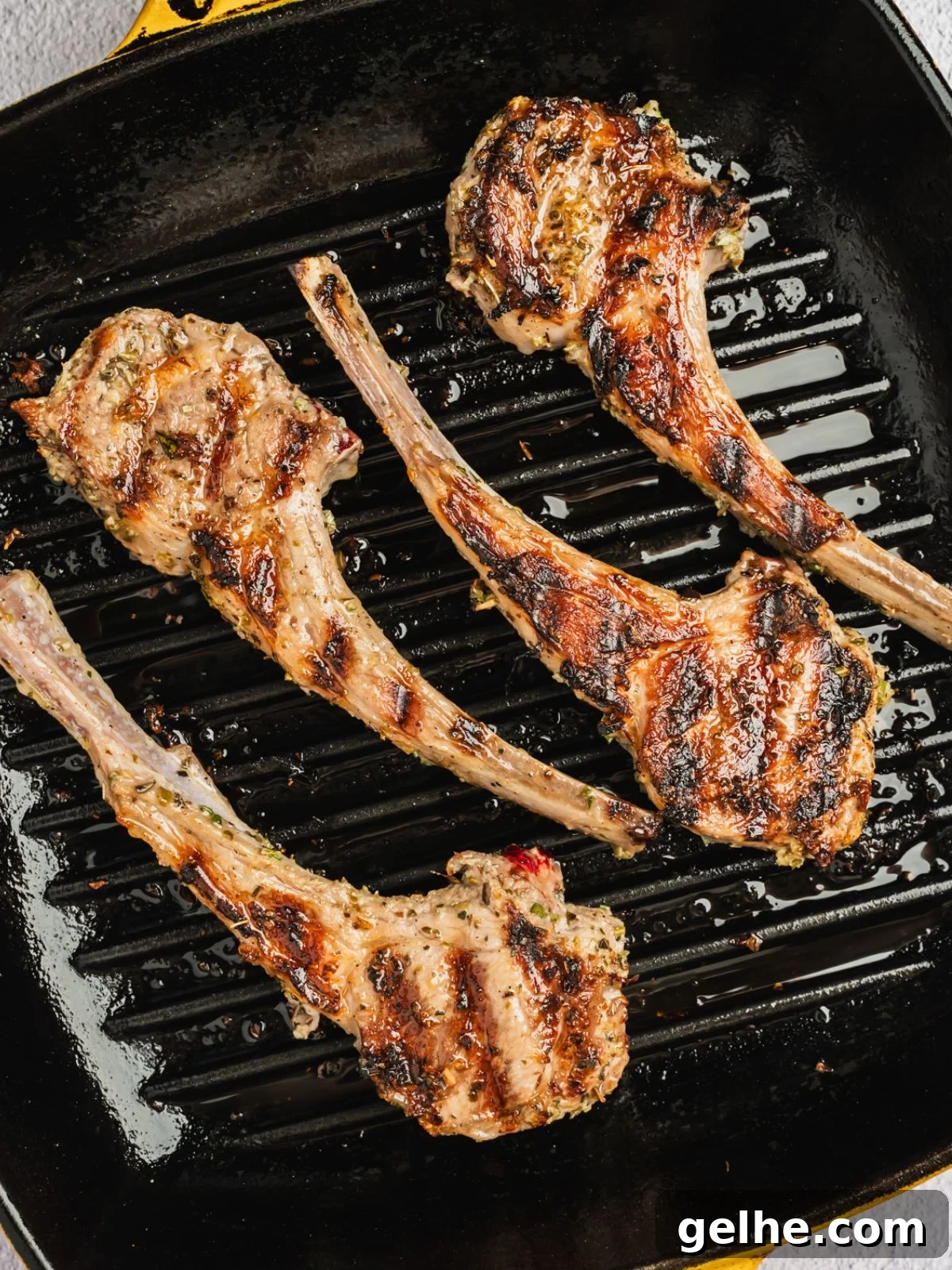 Chops grilling on a grill pan.