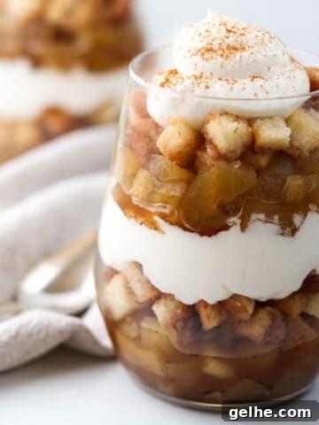Close up of apple trifle topped with whipped cream.