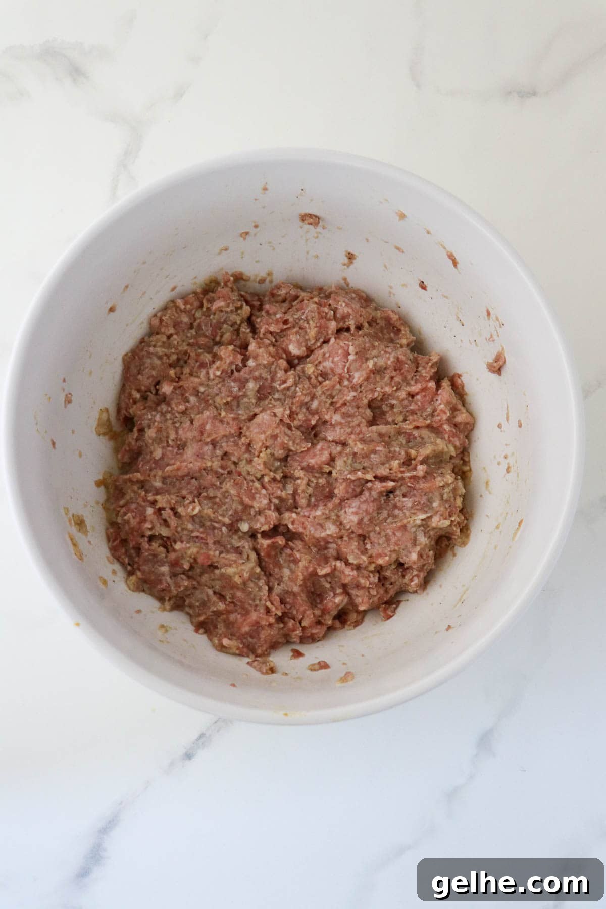 Meatloaf mixture in a white bowl.