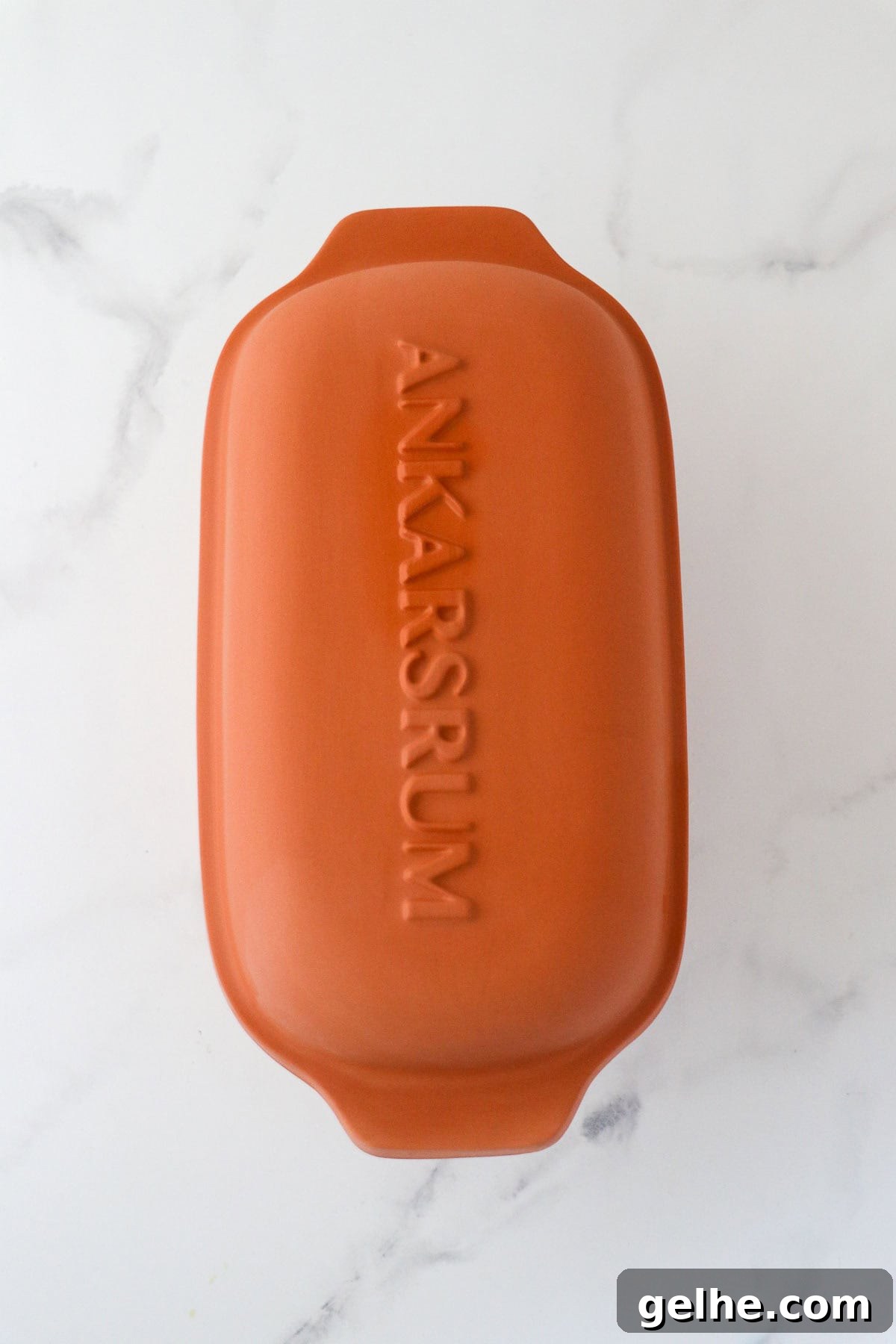 Ankarsrum Clay Baker on a marble surface.