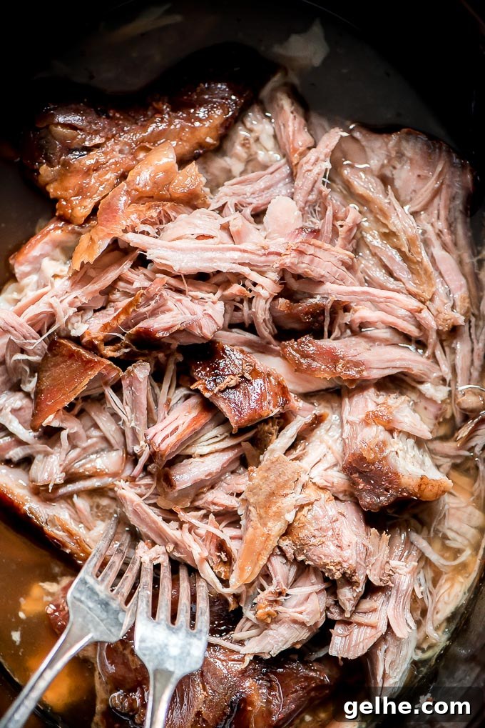 Tender and juicy shredded Slow Cooker Kalua Pork in Crock-Pot.