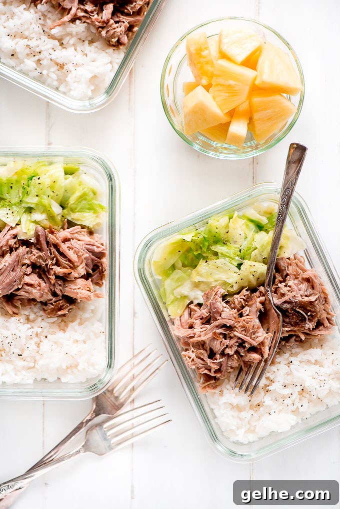Meal Prep Kaula Pork in glass containers along with rice, cooked cabbage and a side of pineapple.