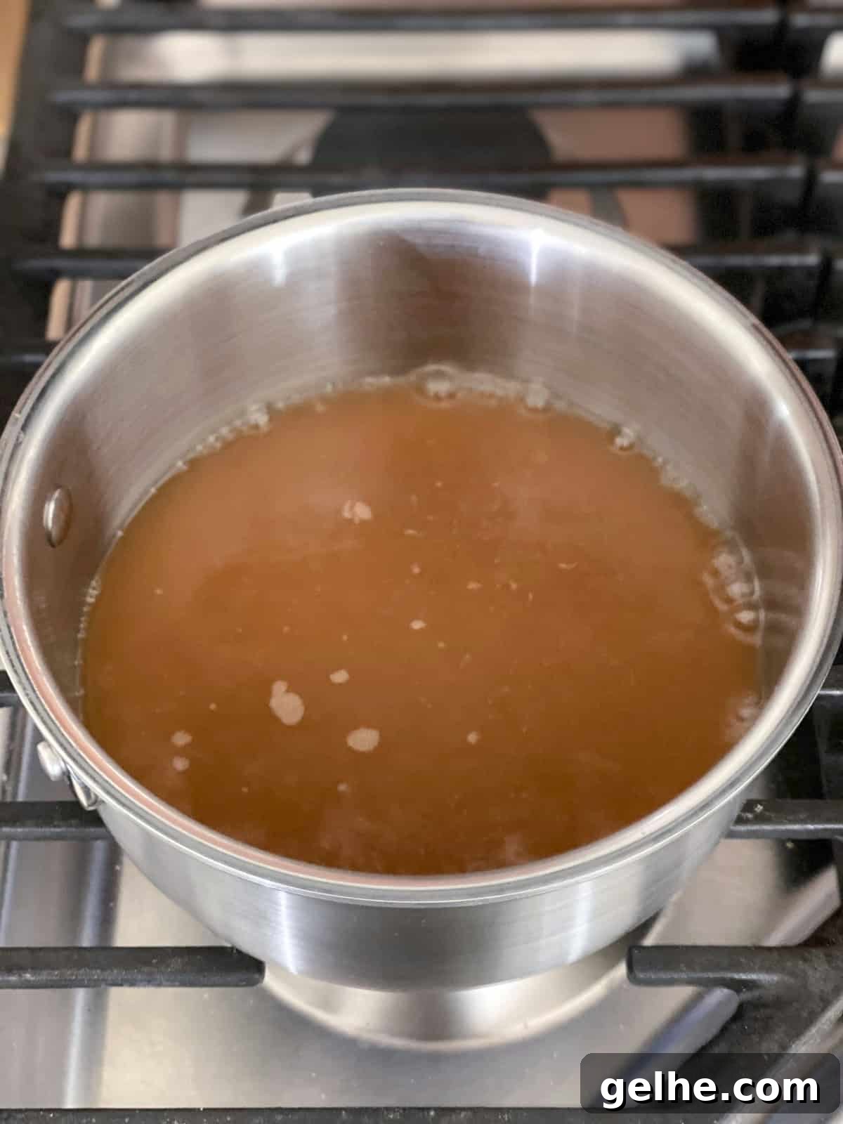 Baked Apple Cider Donuts Recipe | Light Autumn Donut Treat 4 apple cider reducing on stove