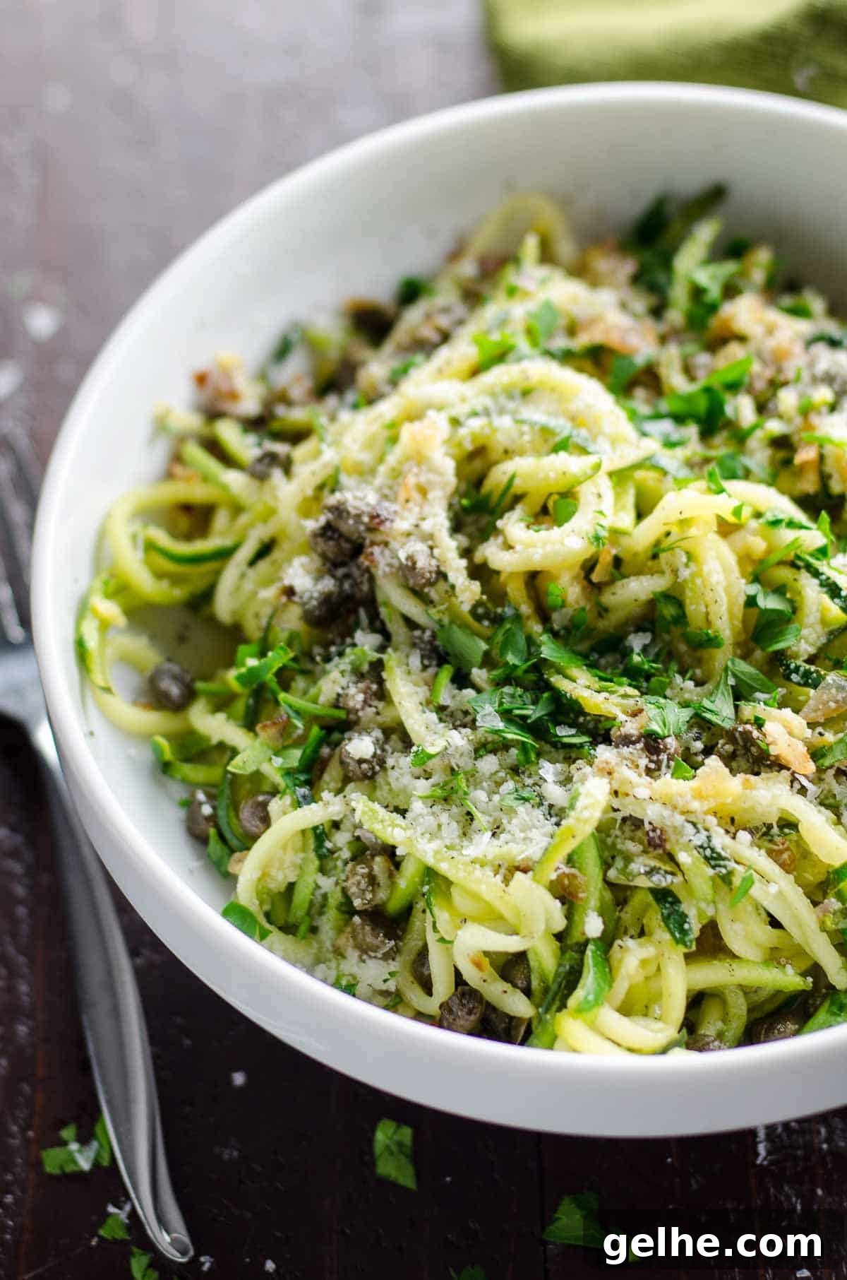 Lemon Caper Butter Zoodles Recipe: Quick Zucchini Noodles 2 zoodles recipe with lemon caper butter in a white bowl with a fork and green napkin