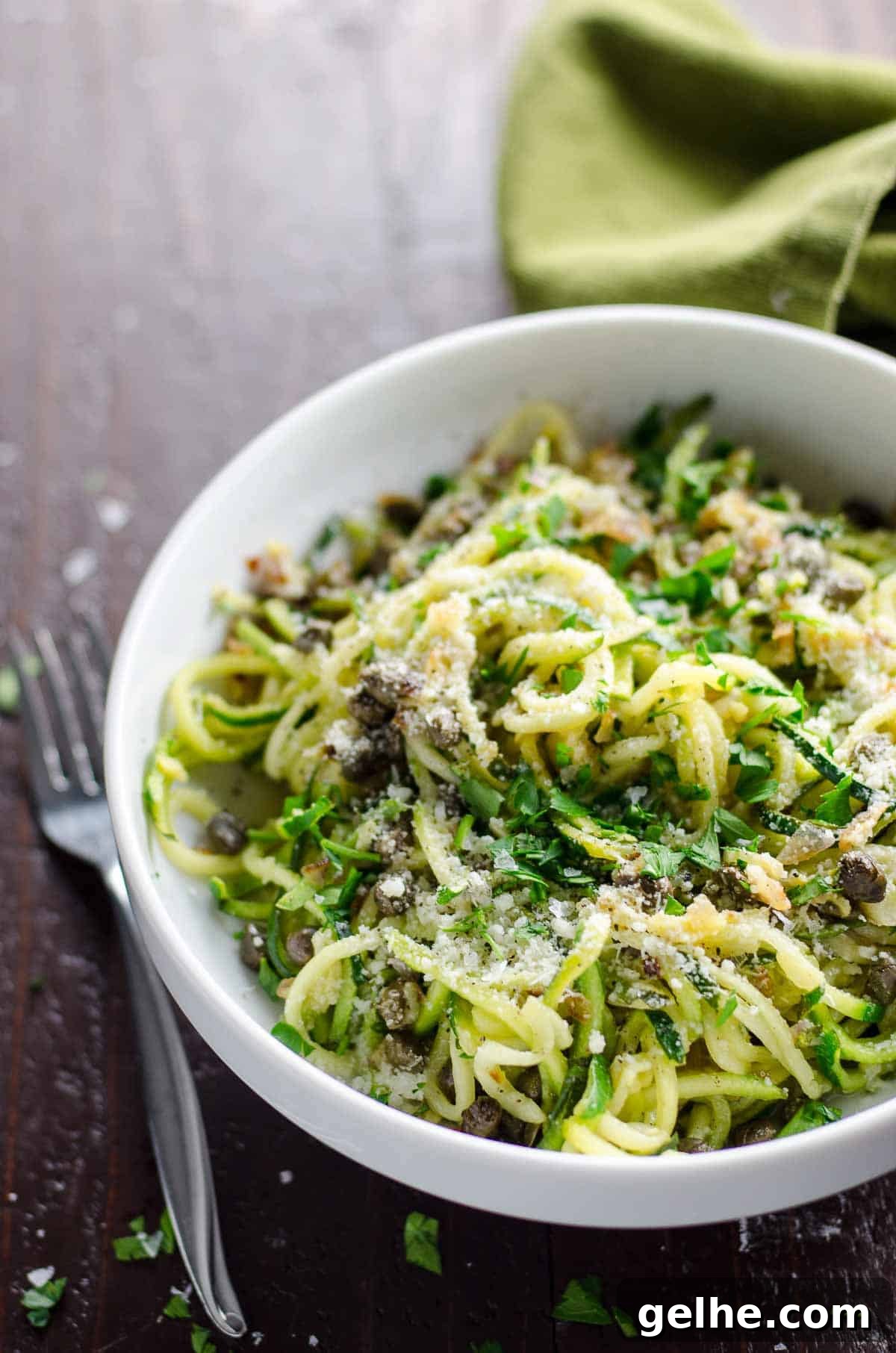 Lemon Caper Butter Zoodles Recipe: Quick Zucchini Noodles 5 zoodles recipe with lemon caper butter in a white bowl with a fork and green napkin