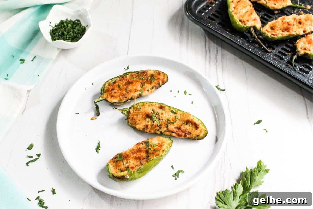 Three jalapeño poppers on white plate.
