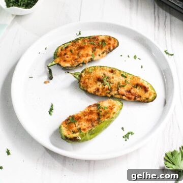 Three jalapeño poppers on white plate.