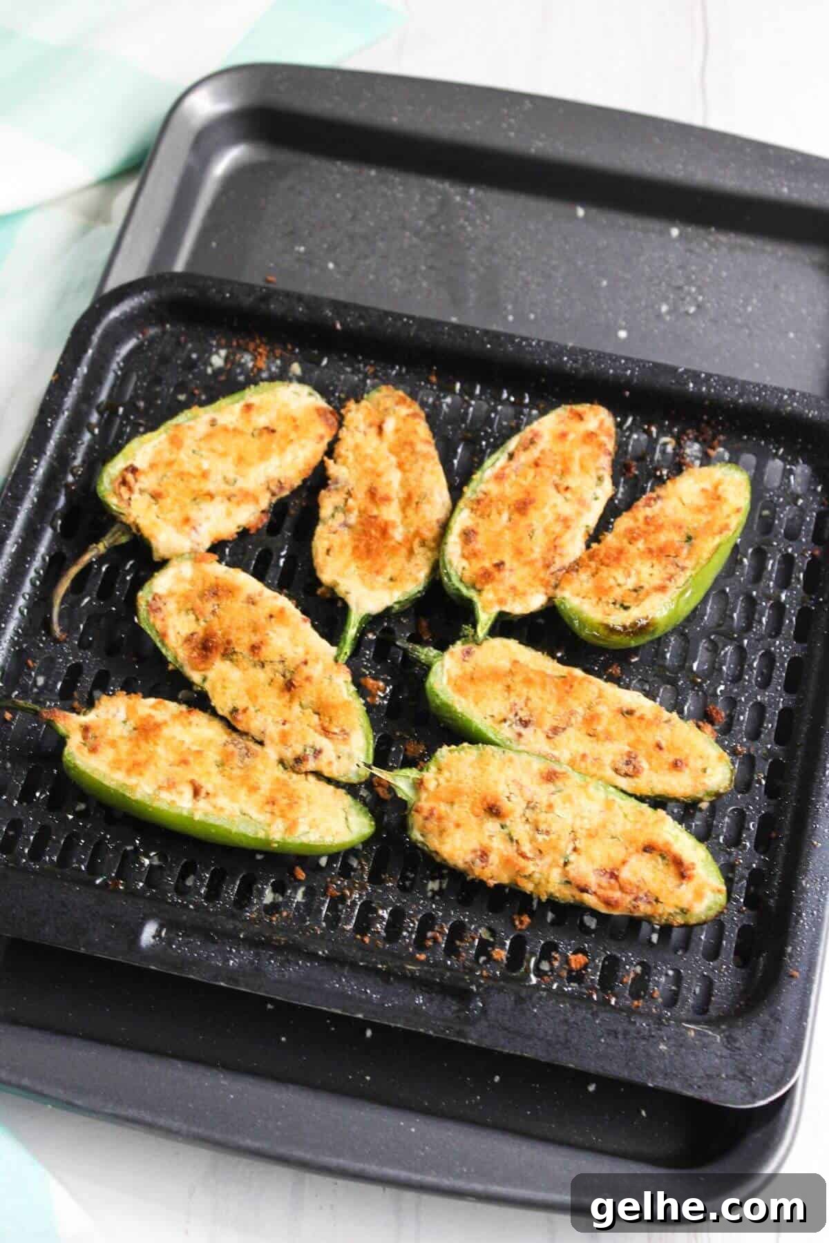 Air-fried jalapeño poppers on air fryer tray.