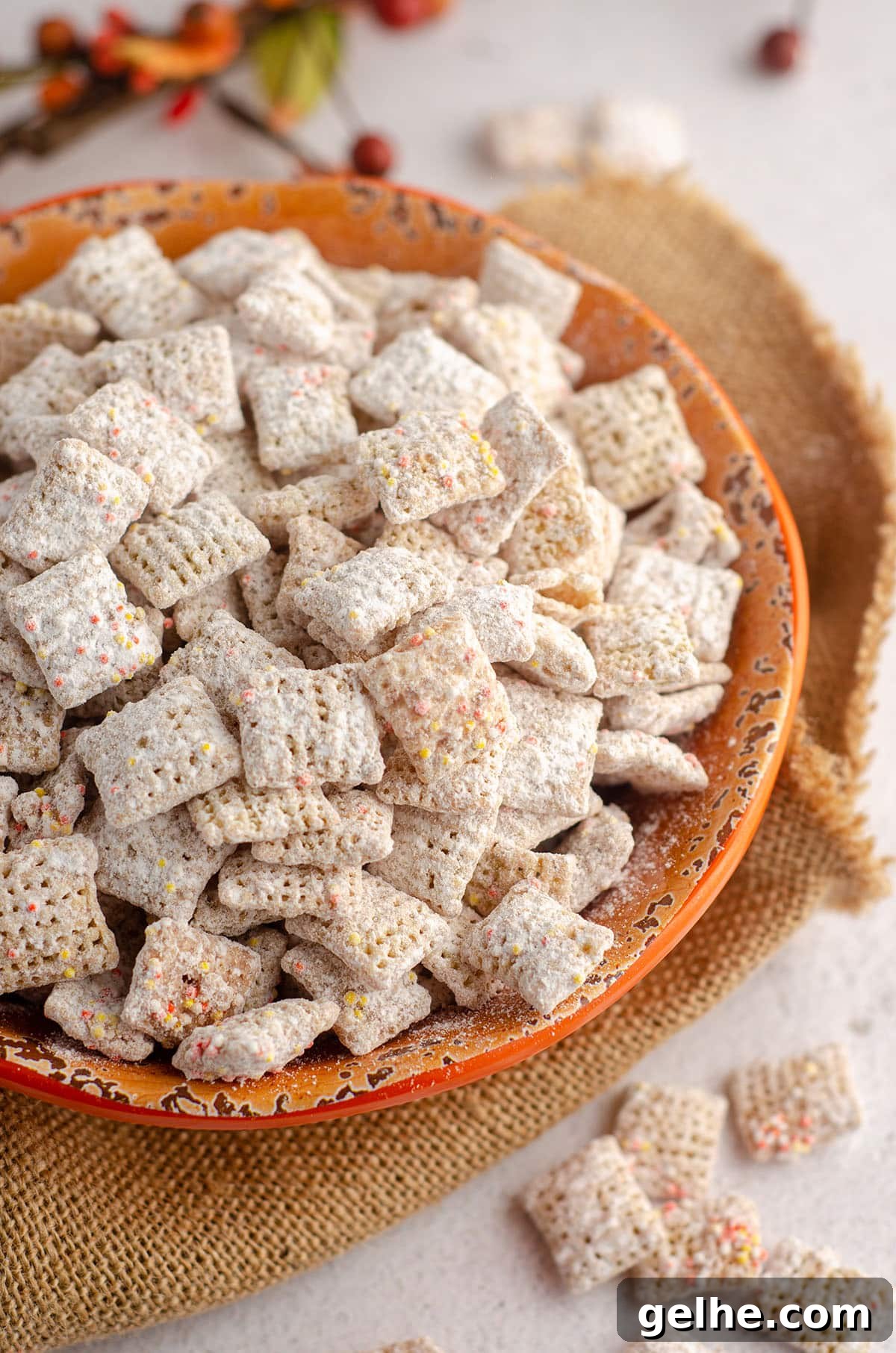 pumpkin spice puppy chow in an orange bowl