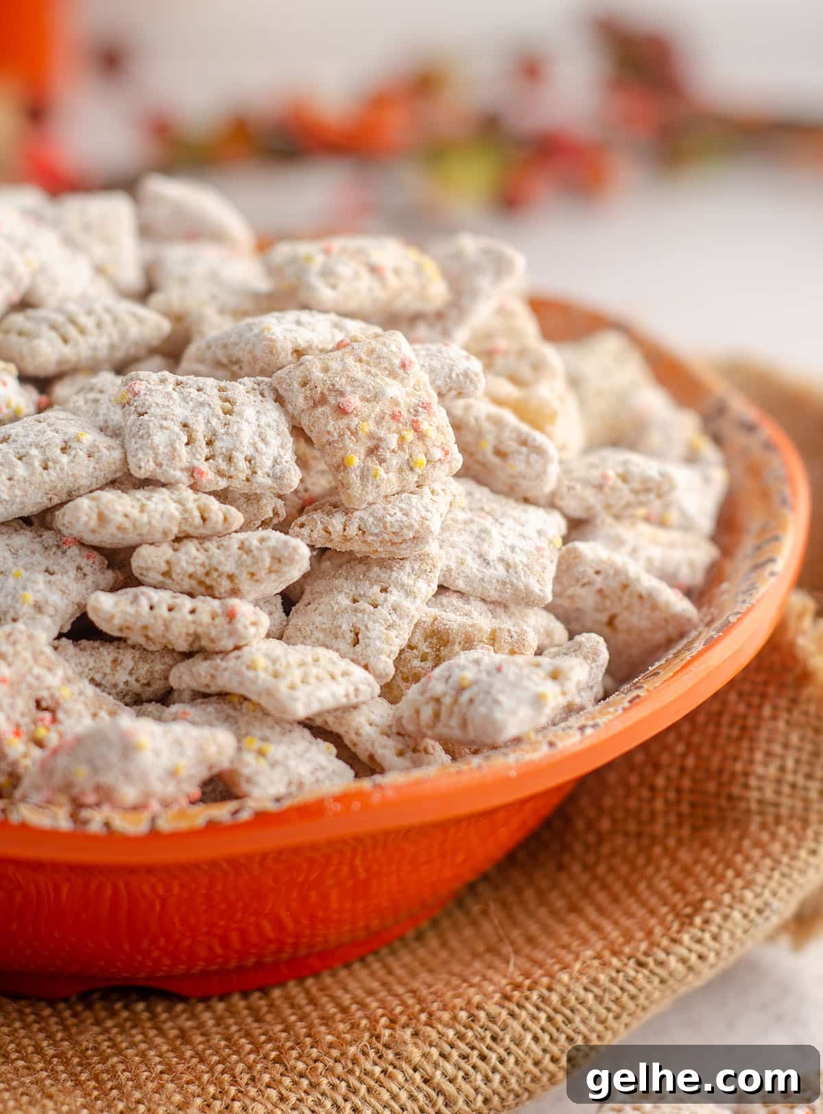 pumpkin spice puppy chow in an orange bowl