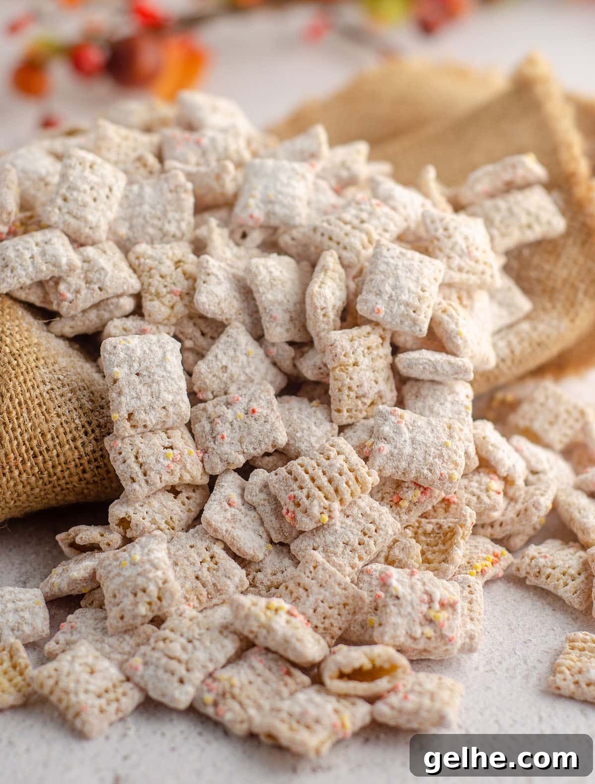 pumpkin spice puppy chow scattered on top of burlap