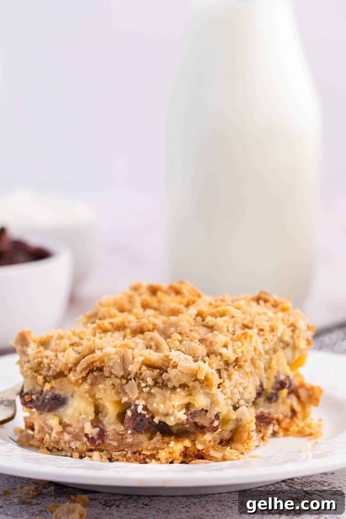 A sour cream raisin bar on a plate.