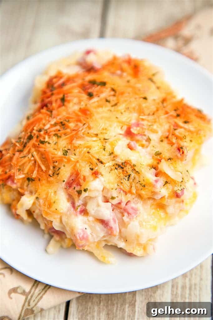 slice of ham and cheese hash brown casserole on a plate