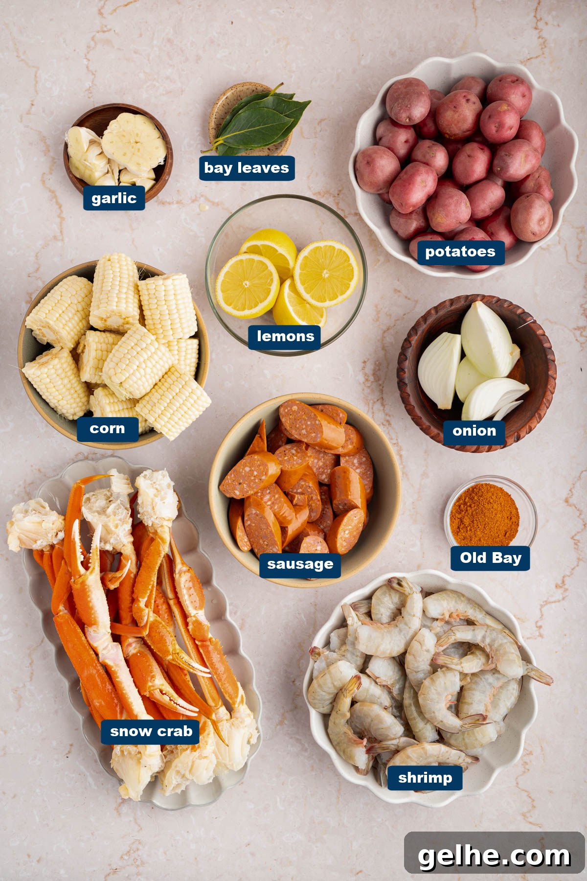 Some of the ingredients for seafood boil in bowls on a countertop.