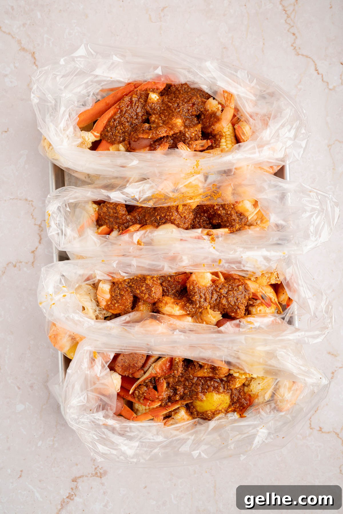 The seafood boil in the bags with the sauce poured over it before mixing everything together.