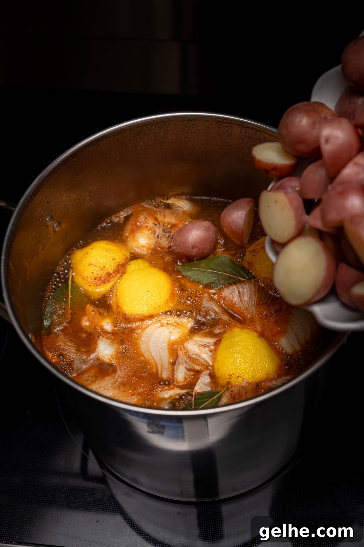 The potatoes in the pot with the other boil ingredients.