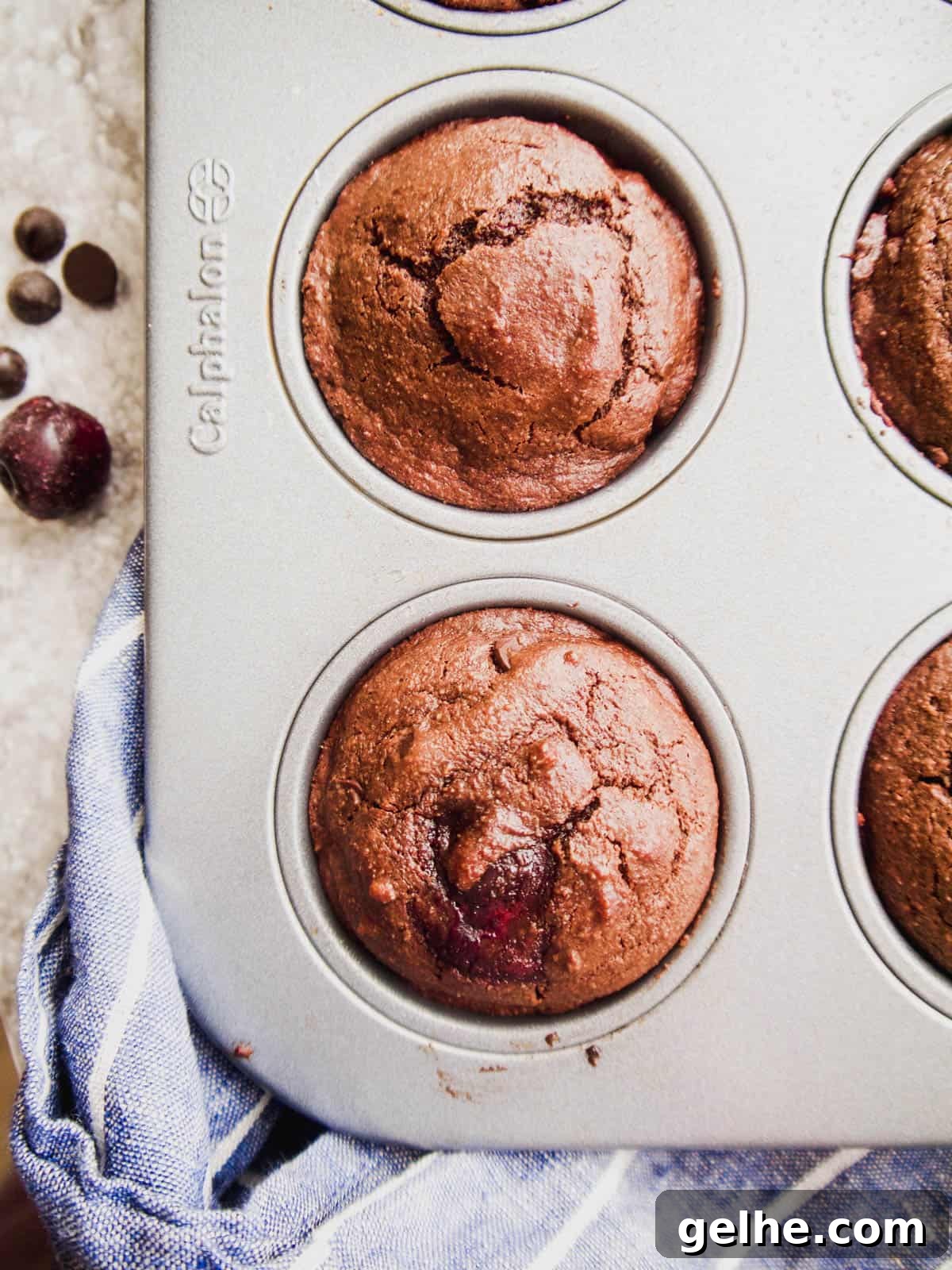 Paleo Chocolate Cherry Muffins — Gluten-Free Recipe 8 Chocolate paleo muffins with cherries in a loaf tin.