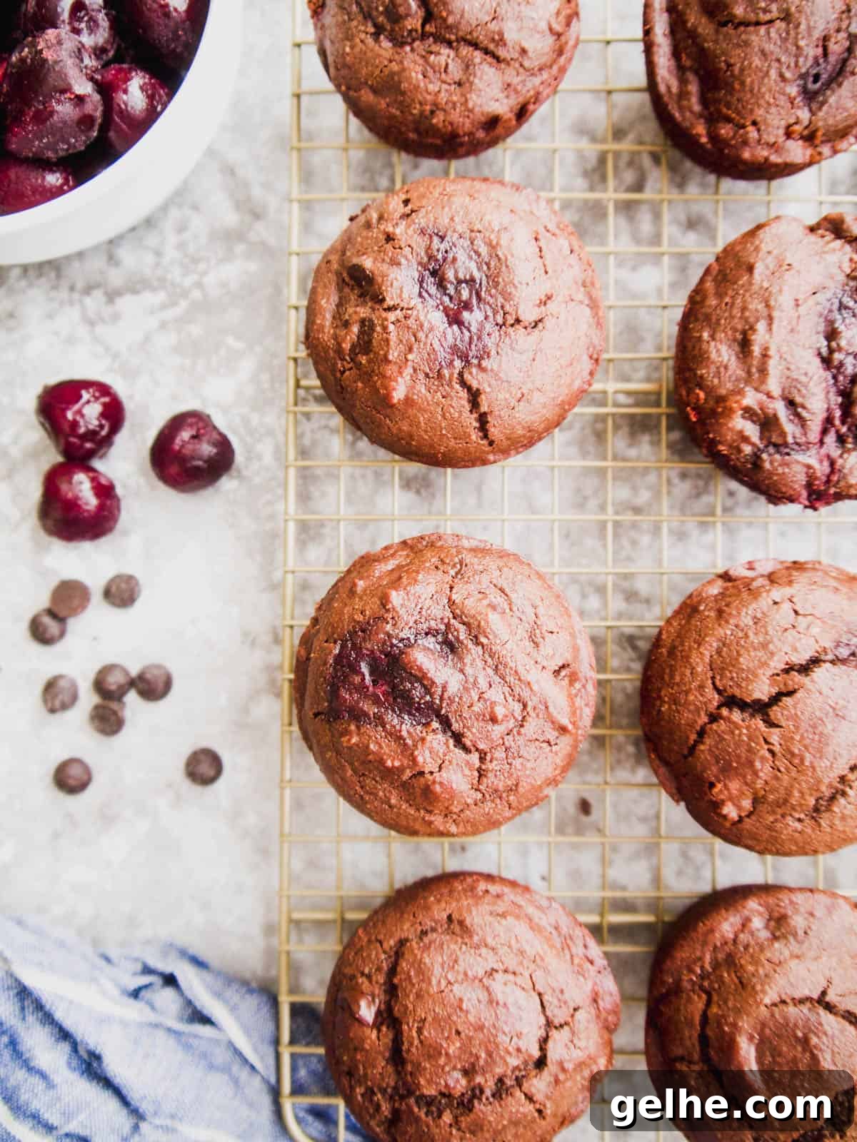 Paleo Chocolate Cherry Muffins — Gluten-Free Recipe 9 Healthy chocolate muffins with cherries cooling on drying rack.