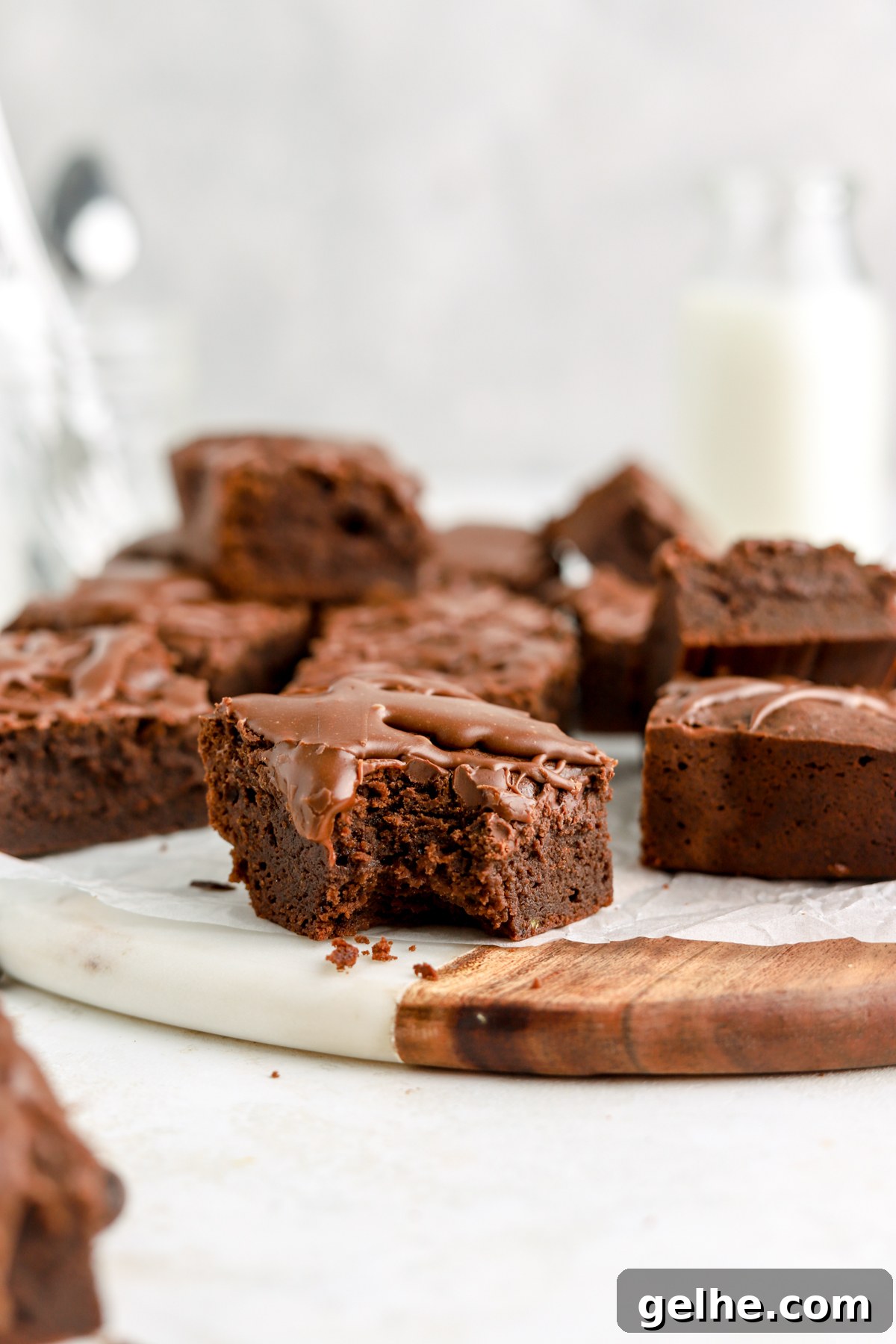 Fudgy Condensed Milk Brownies with a Creamy Caramel Swirl 11 A brownie topped with sauce with a bite taken out of it.