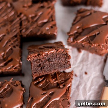 Fudgy Condensed Milk Brownies with a Creamy Caramel Swirl 16 Fudgy brownies cut into squares and a knife.
