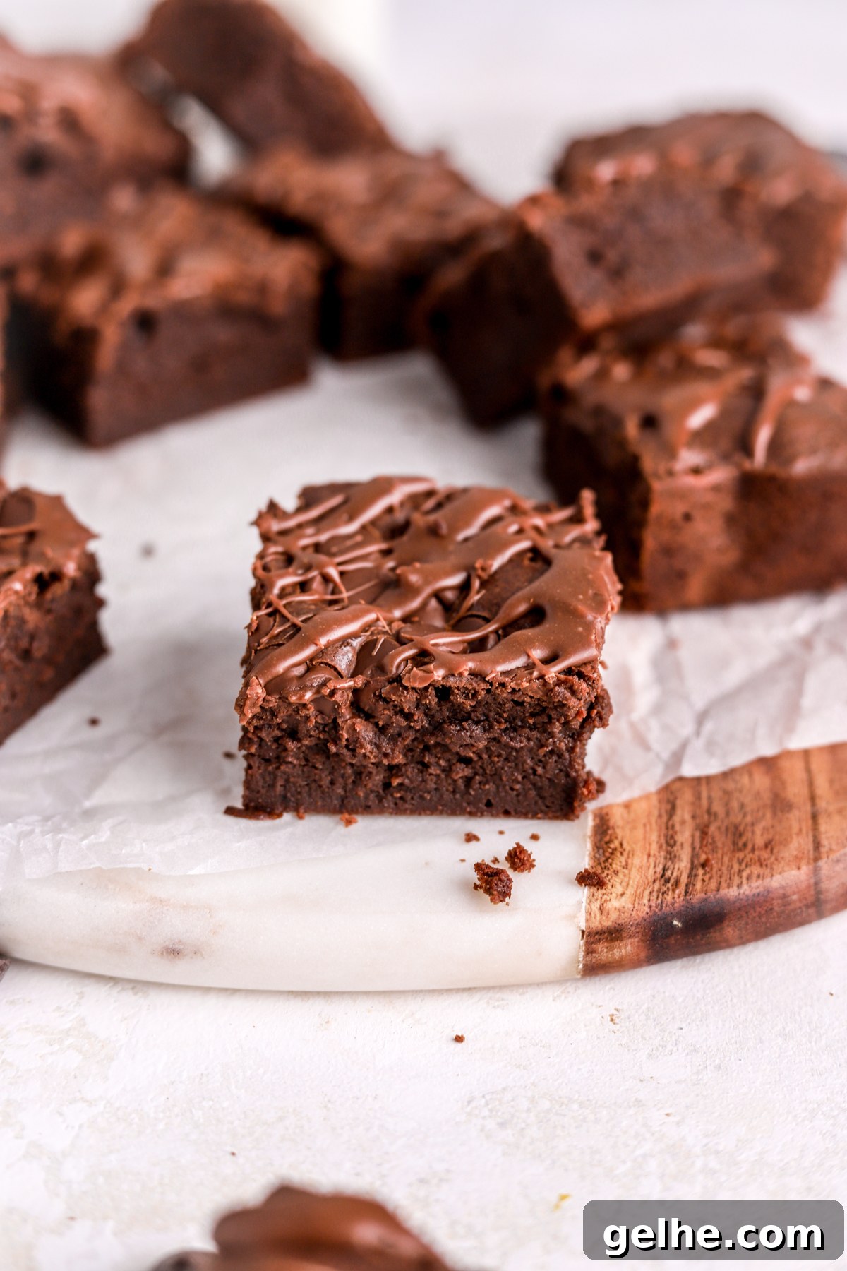 Fudgy Condensed Milk Brownies with a Creamy Caramel Swirl 10 A close up of a brownie with chocolate sauce on top.