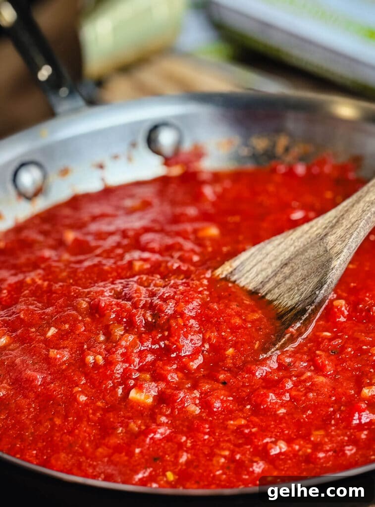 red sauce cooking in stainless steel skillet