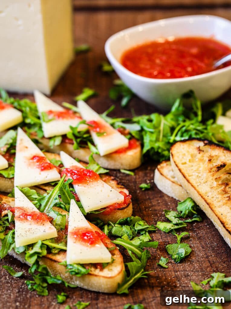 cutting board with manchego cheese and tomato bread appetizer